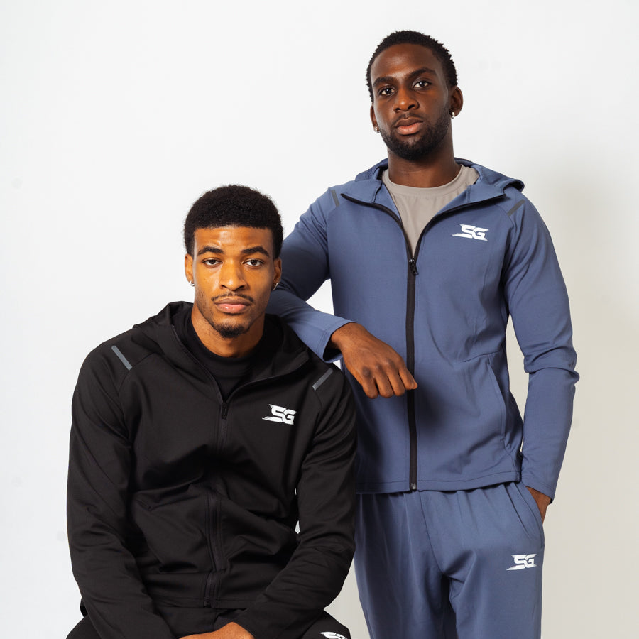 Two men wearing black and blue tracksuits with a logo on a white background